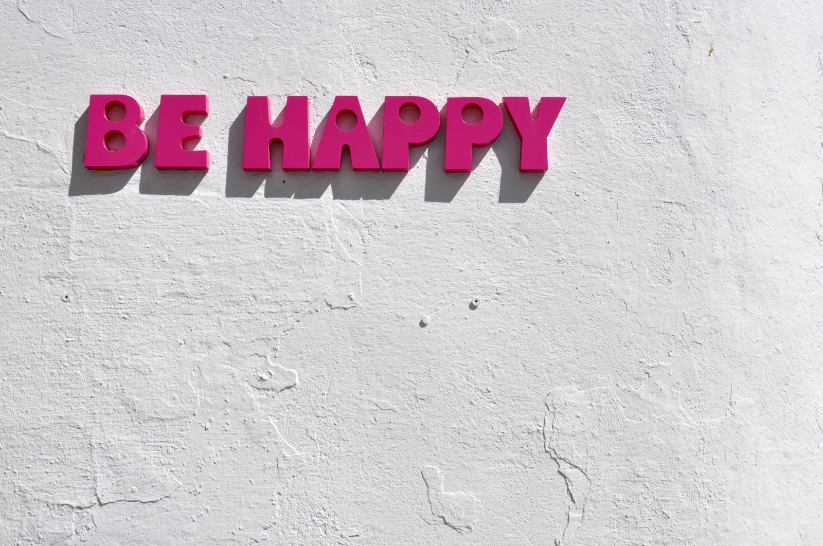 red be happy wall decor” by Alex Block on Unsplash